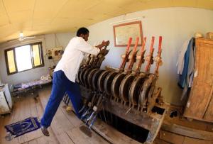 A man changes the tracks for Sudan's new Nile Train in the points room at a station in Khartoum